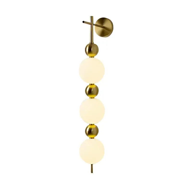 Modern gold led wall sconce featuring brass finish, frosted glass spheres, and metallic accents for bedroom decorbites led wall