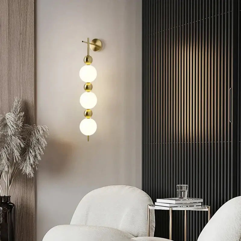 Modern gold led wall sconce with frosted glass spheres and polished brass accents for elegant bedroom decorbites led wall lighting