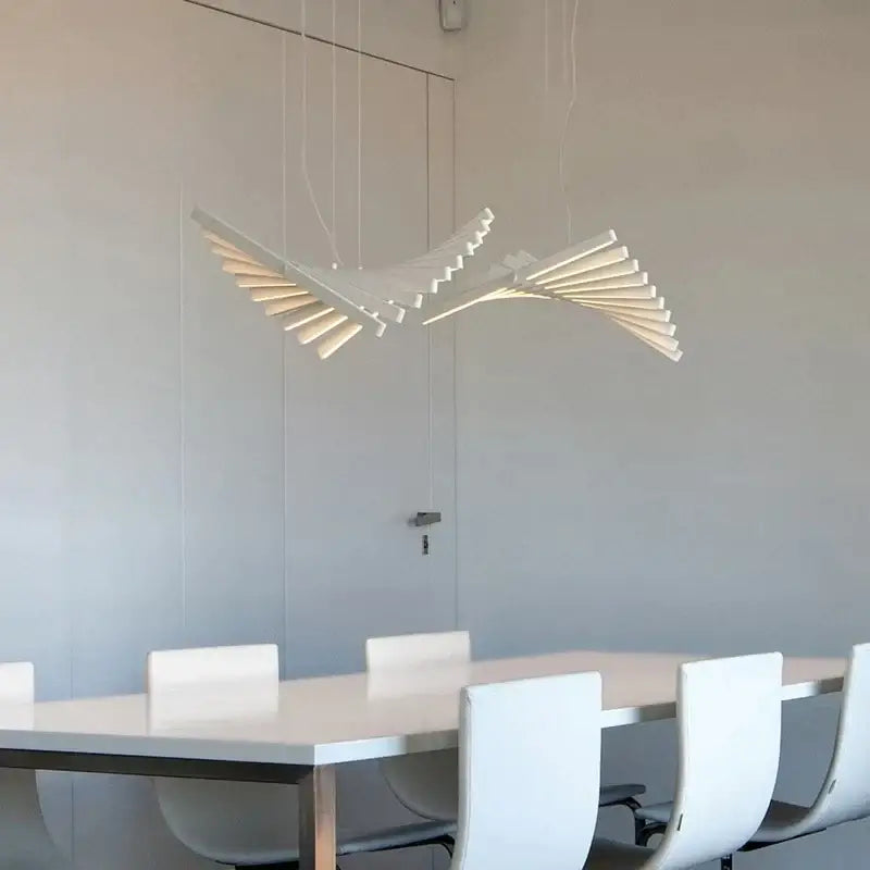 Modern gold led wave pendant chandelier features a white sculptural bird-shaped decorbites led wave design above dining table