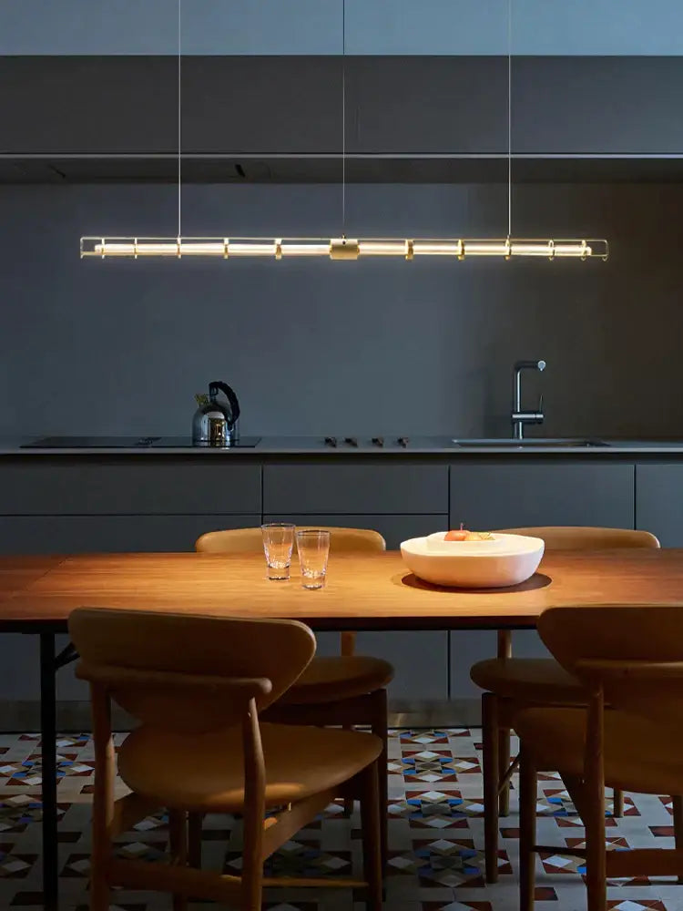 Modern gold linear glass dining room chandelier pendant light with sleek metallic frame and warm illumination for decorbites glass dining