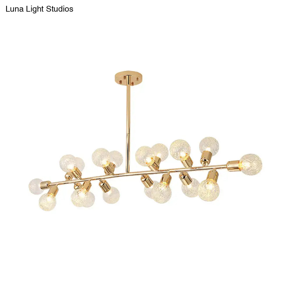 Modern gold linear island light with ribbing glass shade featuring frosted globe bulbs on a sleek metallic branch design