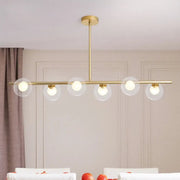 Modern gold linear island light fixture with five clear glass globe shades brass island light fixture