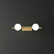 Modern gold linear wall sconce with two spherical milky ball glass globes for bathroom lighting