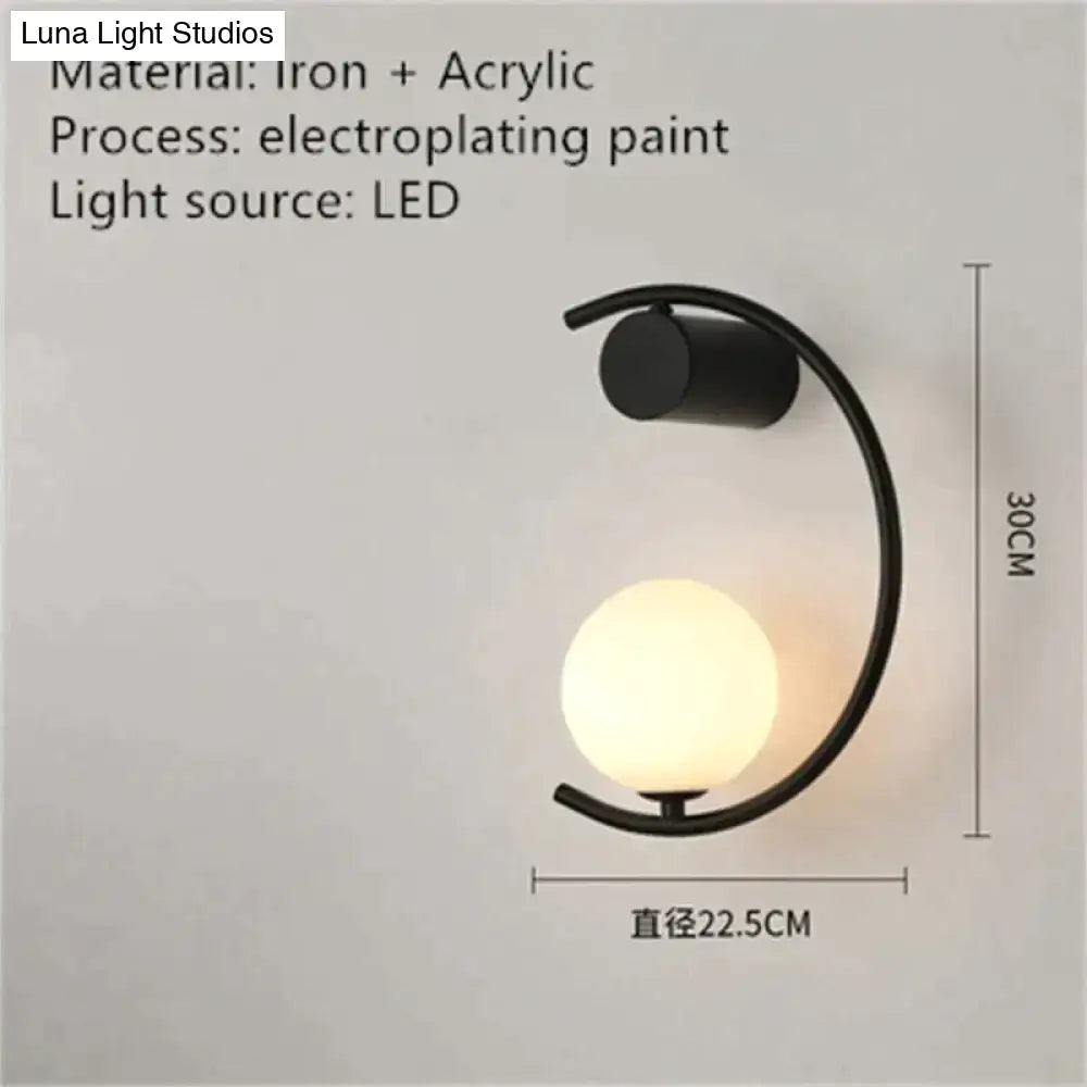 Black iron and acrylic led bedside wall sconce with curved arm and spherical glowing light for luxury creative led use