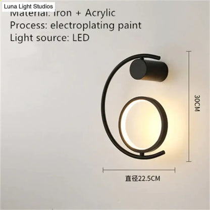 Black iron and acrylic luxury creative led bedside wall sconce with sleek curved design and warm led light glow