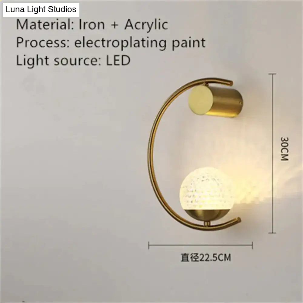 Modern gold luxury creative led bedside wall lamp with curved iron frame and acrylic globe diffuser for bedroom sconce
