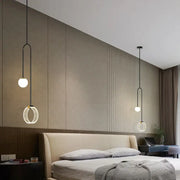 Modern black pendant light with spherical bulbs and circular rings complements decorbites gold luxury led bedroom art