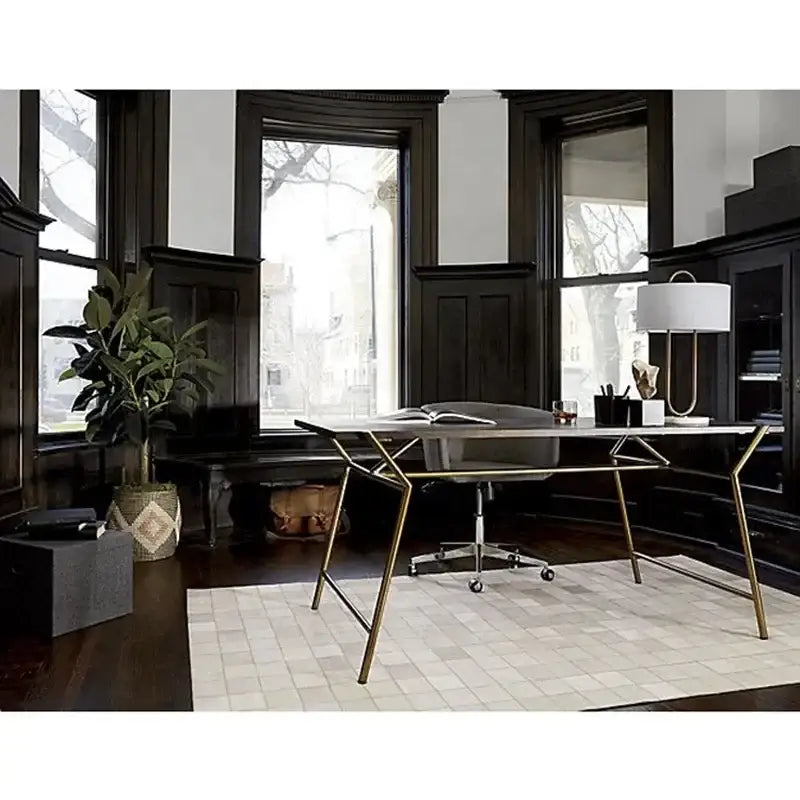 Modern desk with sleek metallic frame and dark wood top paired with decorbites gold luxury led table lamp on marble base
