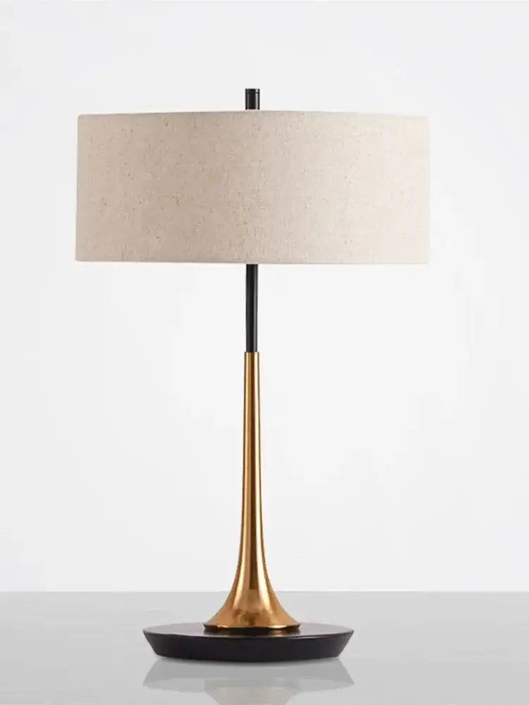 Modern gold luxury led table lamp with tapered gold metal base, black accents, and off-white fabric shade for bedroom decorbites gold luxury