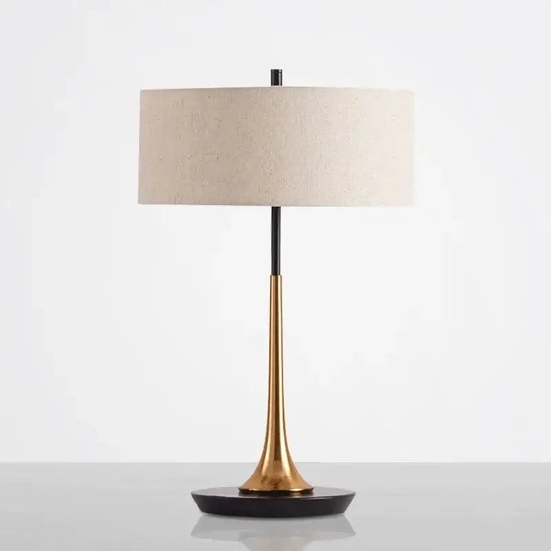 Modern gold luxury led table lamp with sleek two-toned brass and black metal base and off-white linen shade for decorbites gold luxury decor