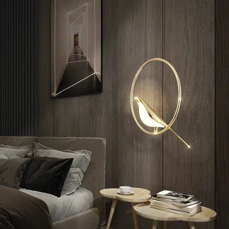 Modern gold magpie bird ceiling chandelier featuring a gold-toned bird-shaped wall sconce with glowing interior light