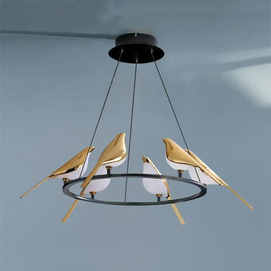 Modern gold magpie bird ceiling chandelier featuring a gold and white bird pendant with a black circular metal frame