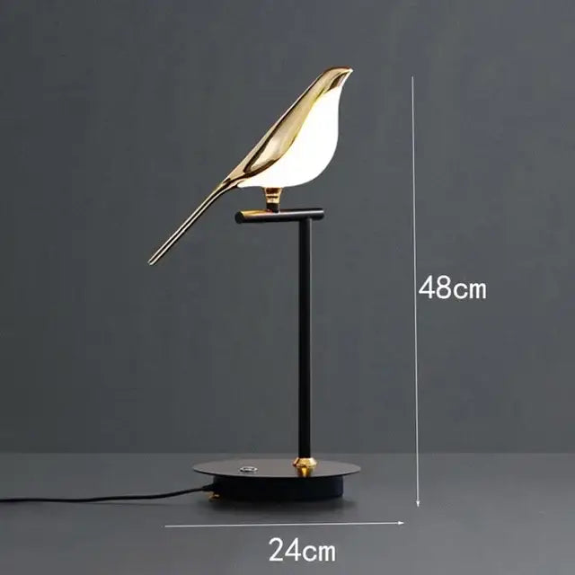 Modern gold magpie bird led chandelier featuring a gold-toned bird-shaped table lamp with sleek design and black base