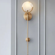 Modern gold marble wall lamp with gold-toned sconce, circular marble-like glass shade, and minimalist slender rod design