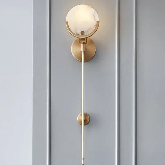 Modern gold marble wall lamp with gold-toned sconce, circular marble-like glass shade, and minimalist slender rod design