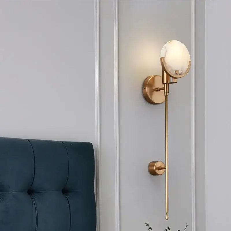 Modern gold marble wall lamp featuring a gold-toned wall sconce with a spherical marble-effect glass shade for minimalist decorbites gold marble lighting