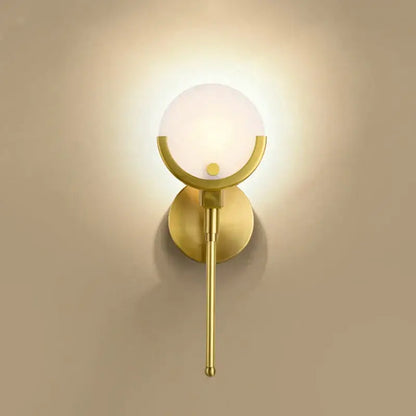Modern gold marble wall lights featuring a gold-toned wall sconce with frosted glass globe for bedroom decorbites decor
