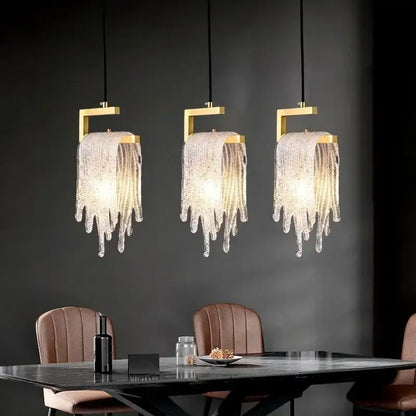 Three elegant modern gold melting ice crystal led pendant lights with decorbites crystal led droplets above dining table