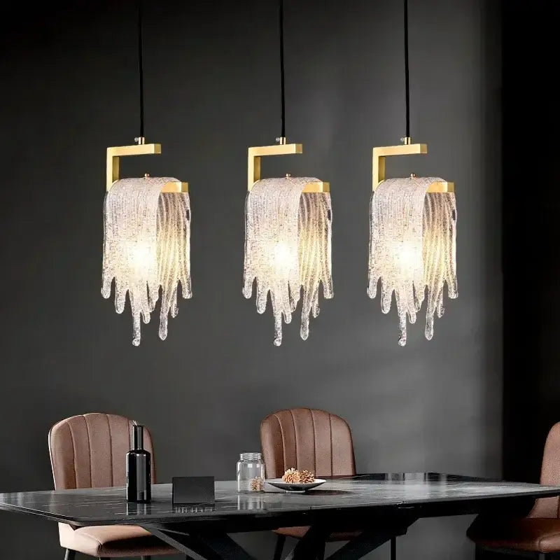 Three elegant modern gold melting ice crystal led pendant lights with decorbites crystal led droplets above dining table