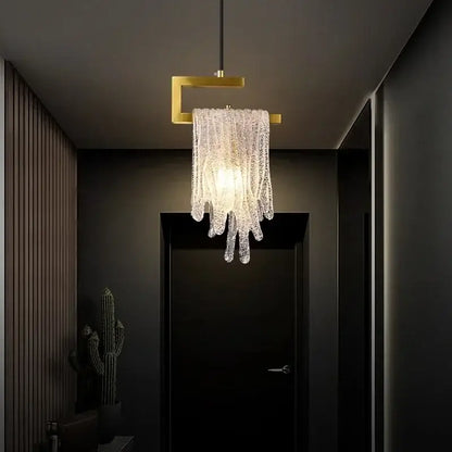 A modern gold melting ice crystal led pendant light with glass strands and a gold-toned square frame decorbites crystal led decor
