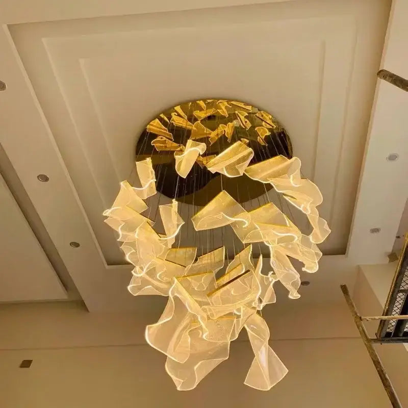 Modern gold mesh duplex building chandelier featuring golden translucent fabric petals suspended from a circular base
