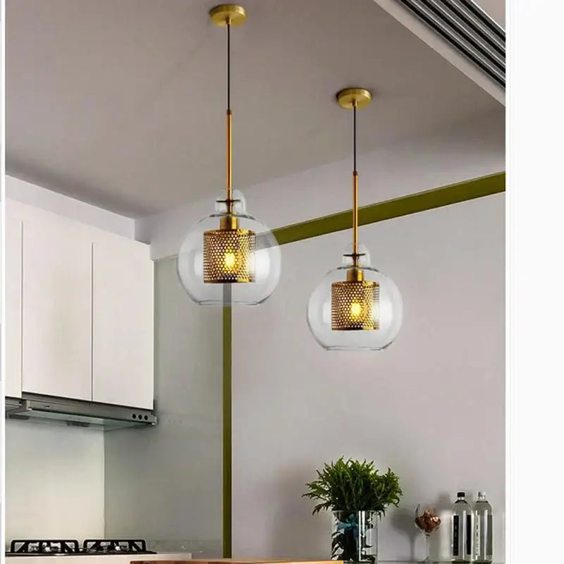 Two modern pendant lights with clear glass ball globes and gold mesh shades for kitchen dining room decorbites glass ball pendant