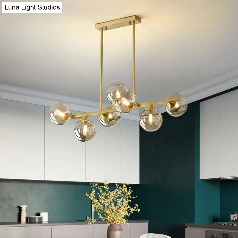 Modern gold metal chandelier with spherical amber glass globes for amber glass island dining room lighting