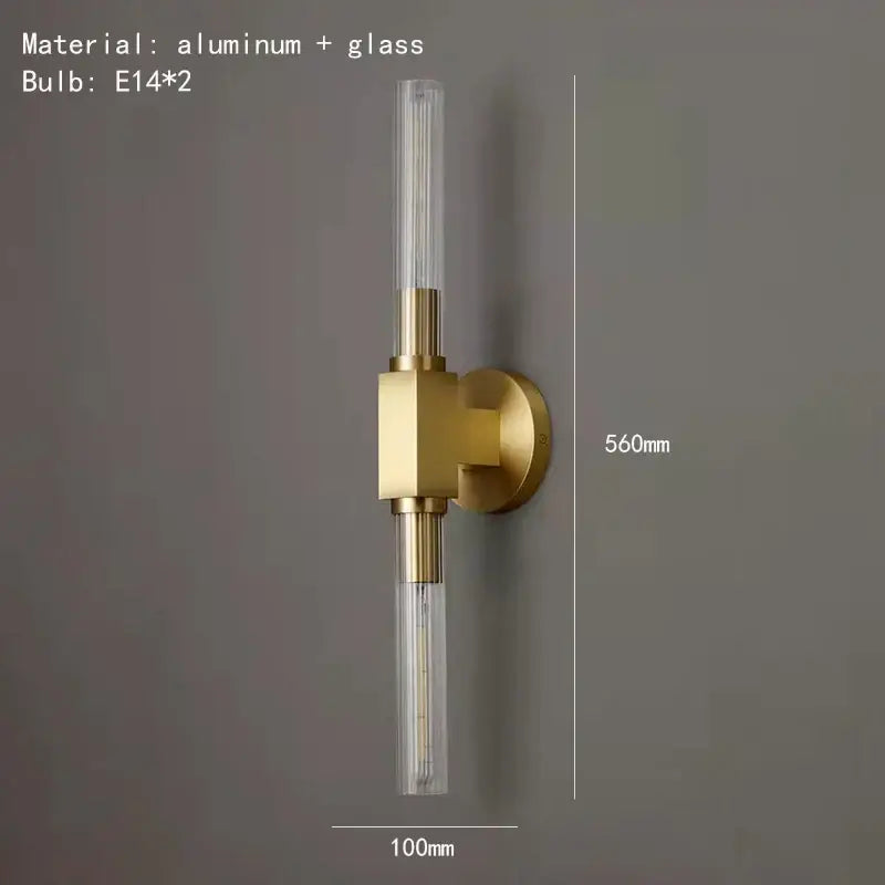Modern gold metal and glass wall sconce light with two clear cylindrical glass tubes for bathroom use