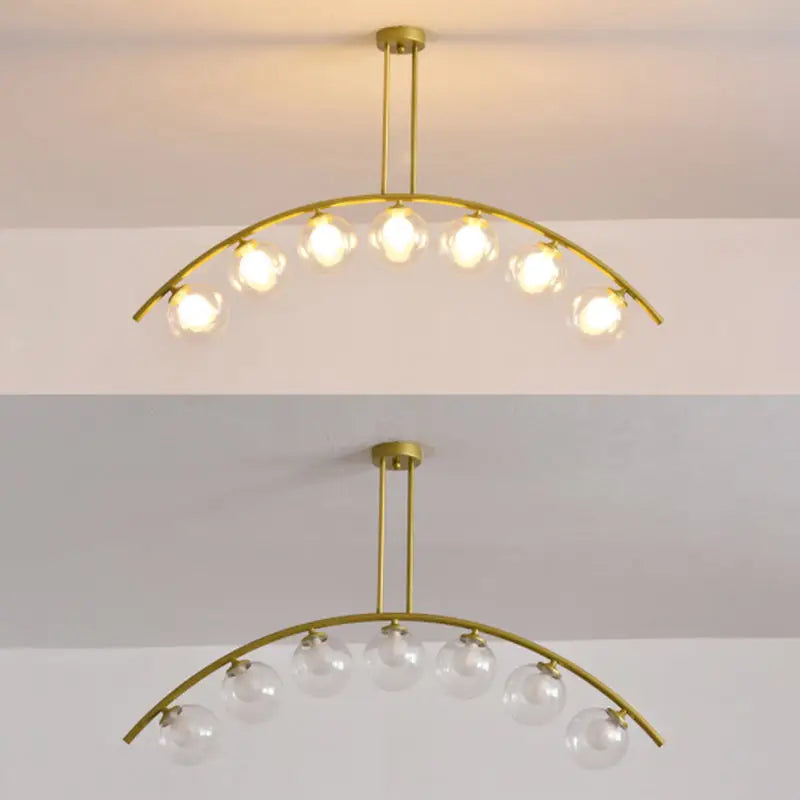 Modern gold metal arched ceiling light with seven clear glass globe bulbs for dining room illumination