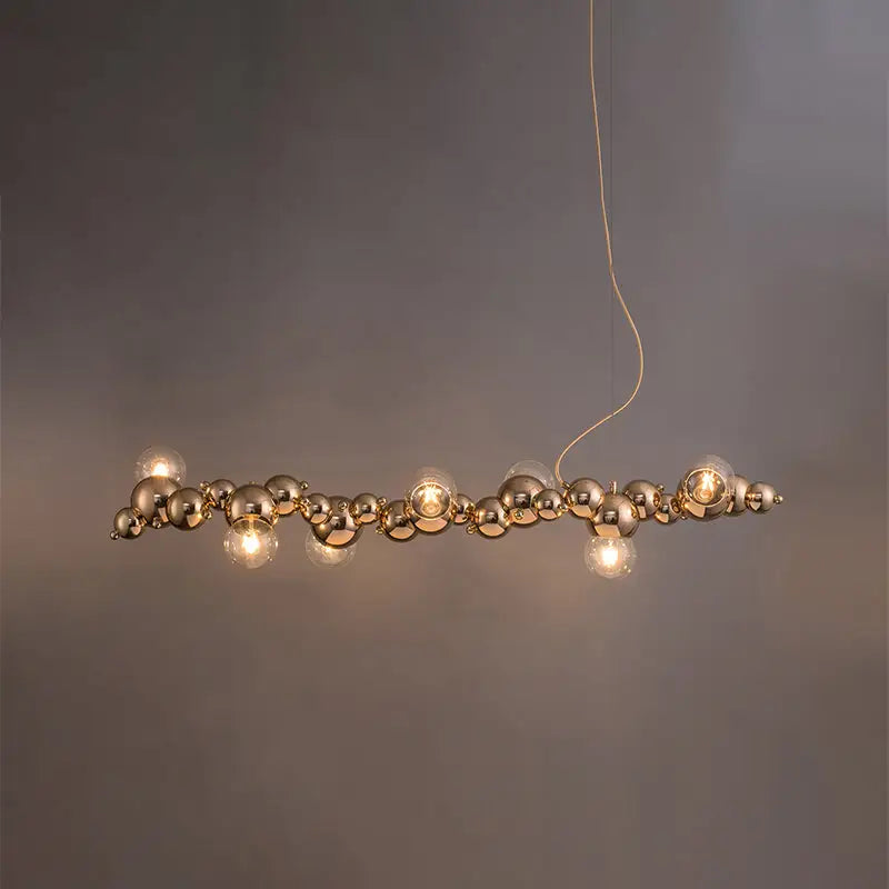 Modern gold metal ceiling light with spherical pendant and chain-like design for dining room with 6 bulbs