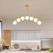 Modern gold metal arched ceiling light with six frosted glass bulbs for dining room illumination