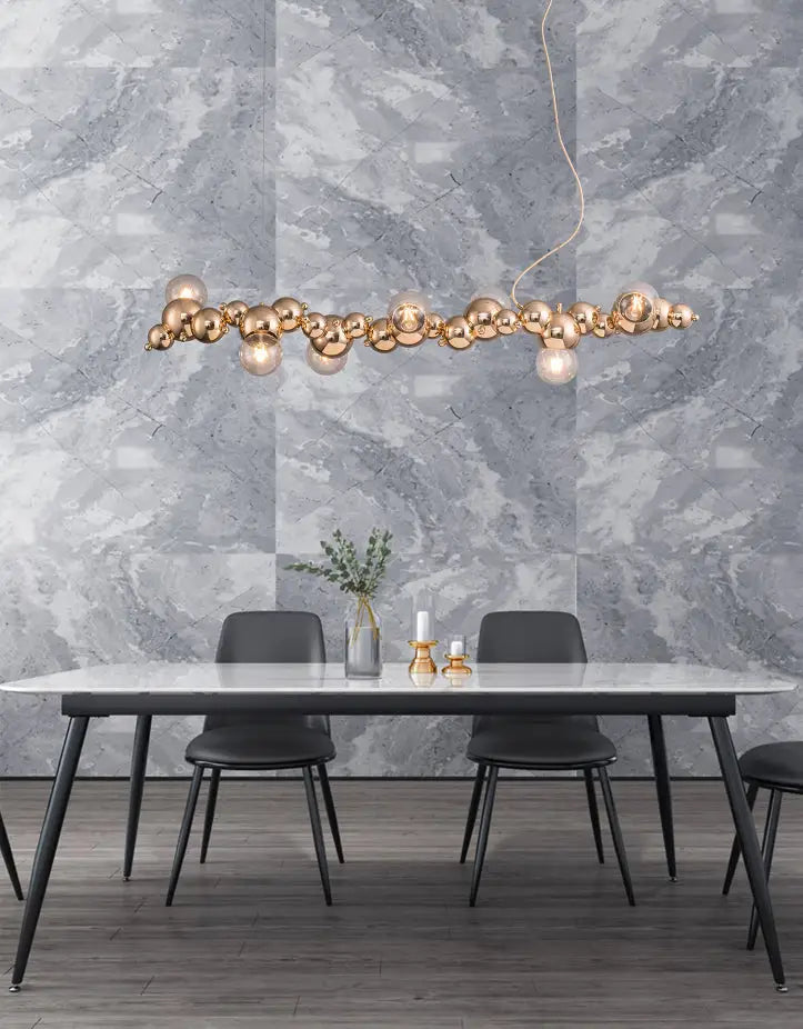 Modern gold metal arched ceiling light with six spherical bulbs in an elongated cluster for dining room use