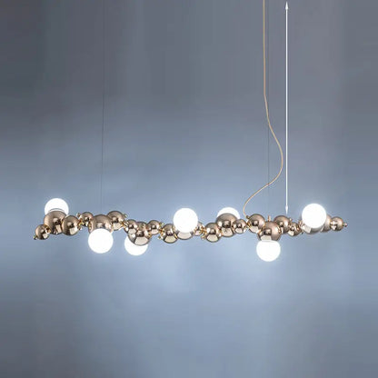 Modern gold metal arched ceiling light with six polished brass spheres and bulbs for dining room use