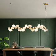 Modern gold metal branching pendant light with brass finish and spherical frosted glass bulbs for dining room decorbites gold metal