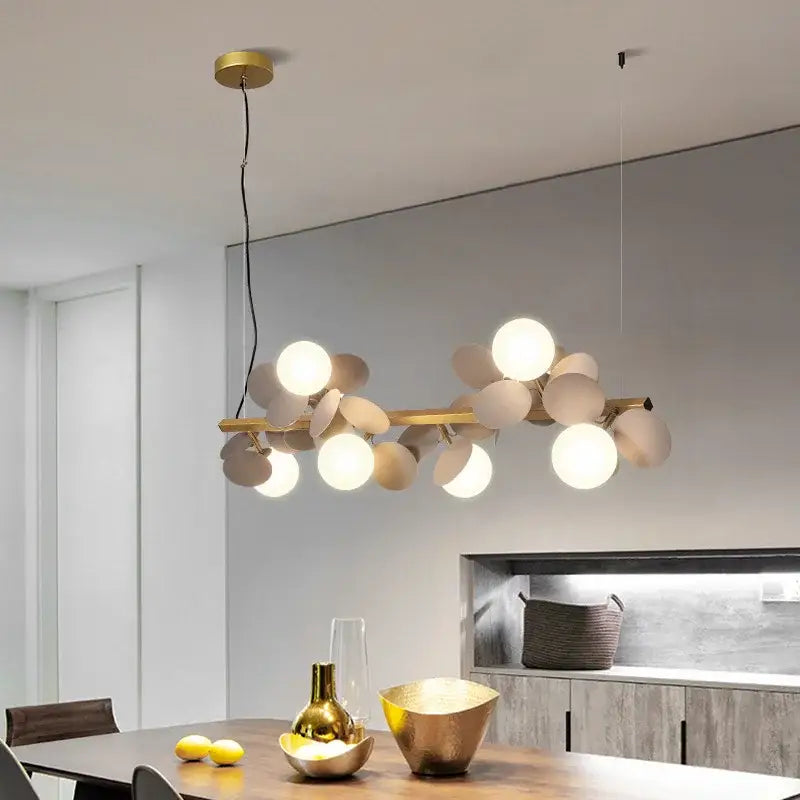 Modern gold metal branching pendant light with spherical frosted glass bulbs for dining room decorbites gold metal
