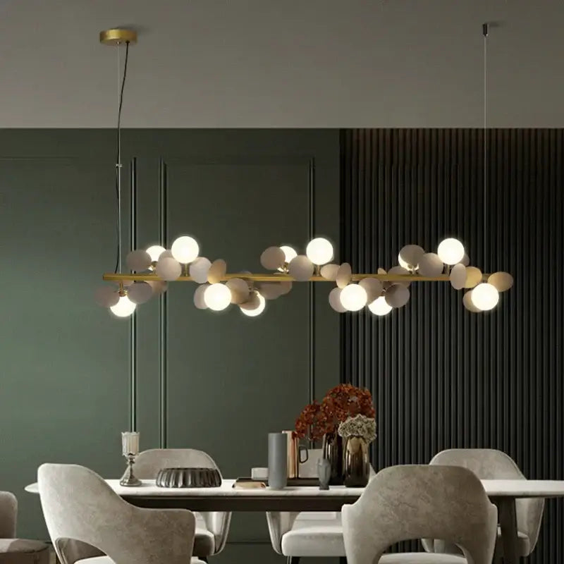 Modern gold metal branching pendant light with gold metal spherical opalescent bulbs for dining room decorbites gold metal