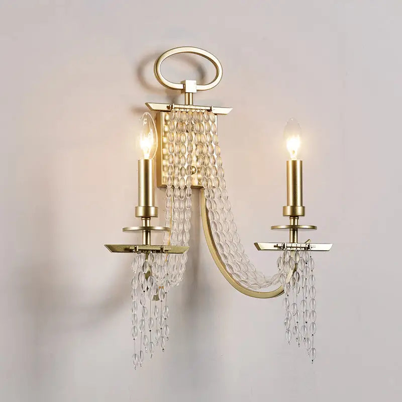 Modern gold metal candle wall sconce with two lights and clear crystal beads for living room lighting