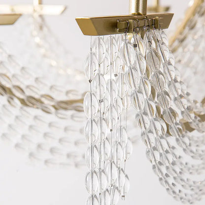 Modern gold metal candle wall sconce with clear faceted crystal chandelier and gold-toned metal frame for living room light