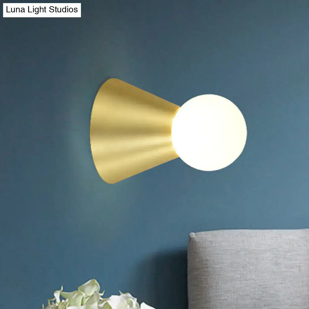 Modern gold metal conical sconce wall light with frosted globe bulb ideal for bedroom lighting