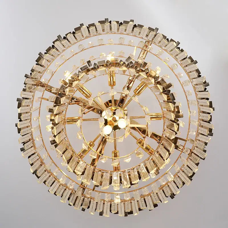 Modern gold metal crystal chandelier with multiple tiers of faceted prisms and polished metal arms for dining room decorbites gold metal
