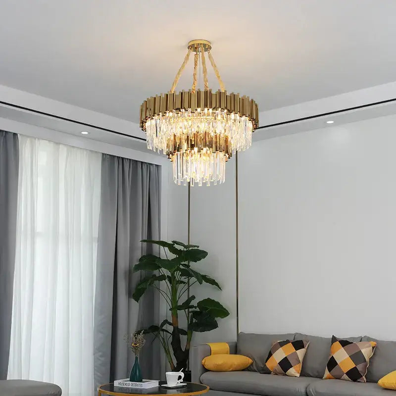 Modern gold metal crystal chandelier with cascading prisms and tiered design for dining room decorbites gold metal pendant light