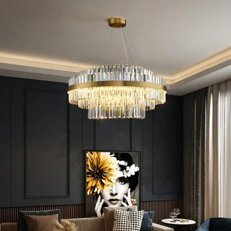 A modern gold metal crystal pendant light with circular frame and cascading clear prisms for dining room decorbites