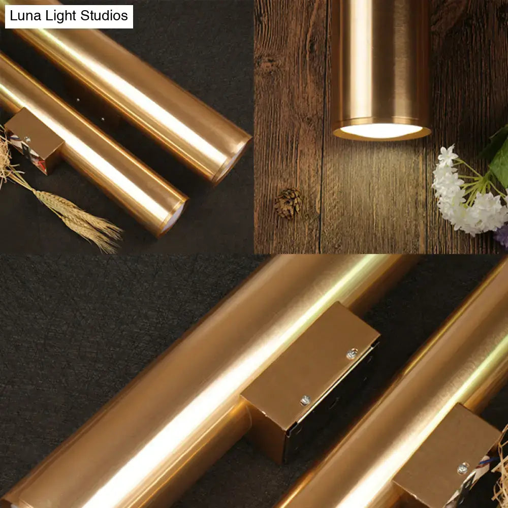 Modern gold copper-finished metal fixture wall lamp with cylindrical design and warm glow for corridor lighting