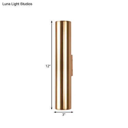 A sleek 12 inch tall brass cylindrical metal fixture wall lamp with polished finish for modern corridor lighting