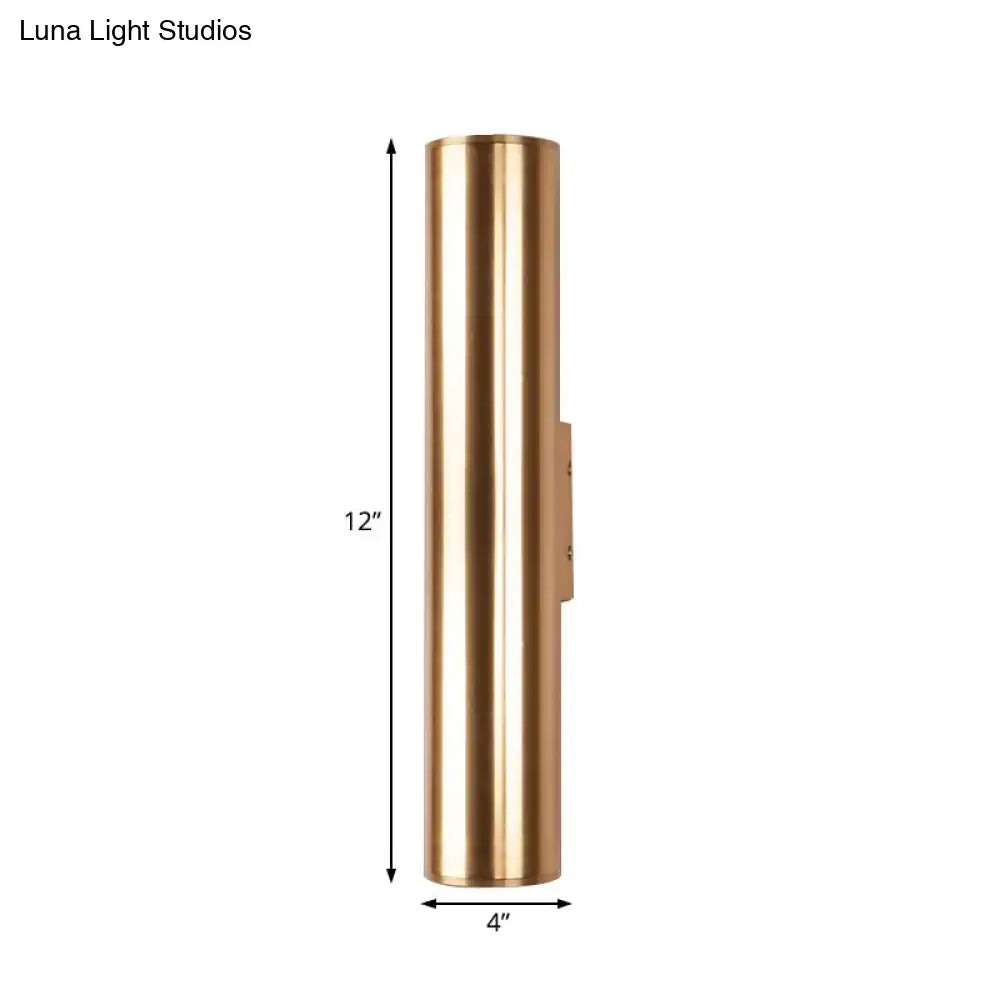 A sleek 12-inch tall brass metal fixture wall lamp with a minimalist design and polished finish for corridor use