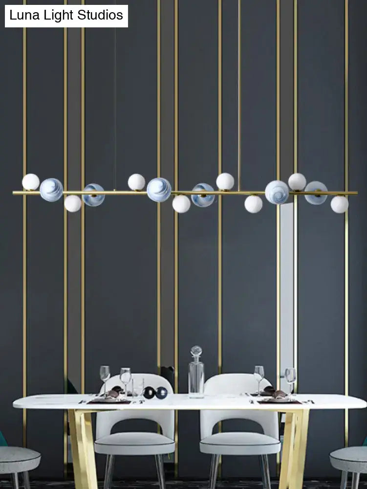 Modern gold metal glass globe chandelier with white and blue marble-effect spheres and adjustable chain cord length for dining table
