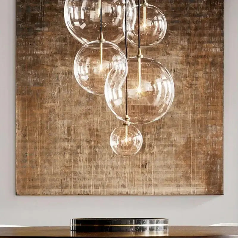 Modern gold metal globe pendant light with clear glass globe and brass accents ideal for dining room decorbites gold metal