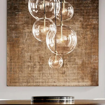 Modern gold metal globe pendant light with clear glass globe and brass accents ideal for dining room decorbites gold metal