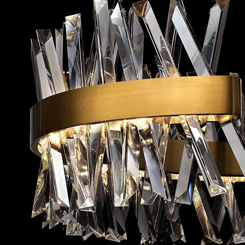 A modern pendant lamp with decorbites gold metal circular frame and faceted crystal prisms for luxury living room decor