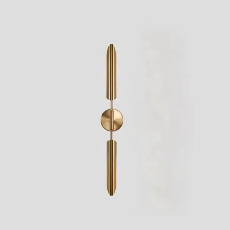 Modern gold metal wall sconce with sleek vertical cylindrical arms and frosted globe for bedroom decorbites gold metal light